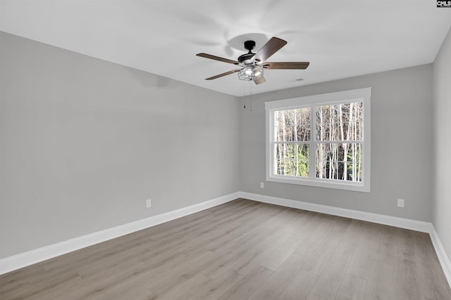 empty room featuring ceiling fan and light hardwood / wood-style flooring