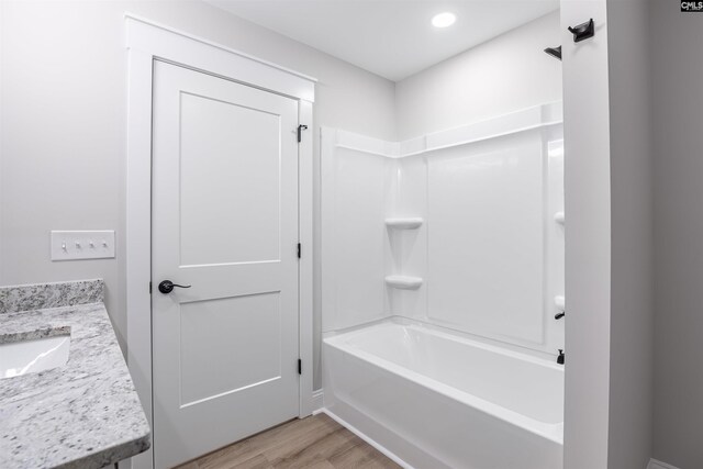 bathroom featuring shower / bathing tub combination, vanity, and wood-type flooring