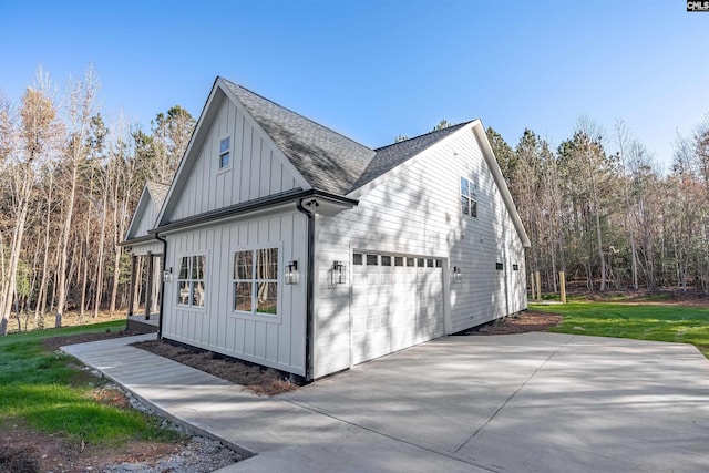 view of side of home with a lawn and a garage