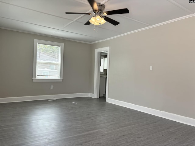 empty room with ceiling fan, dark wood-type flooring, and ornamental molding