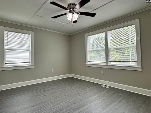 empty room with crown molding, ceiling fan, and dark wood-type flooring