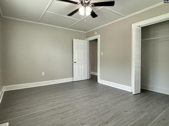 unfurnished bedroom with ceiling fan, a closet, dark hardwood / wood-style floors, and ornamental molding