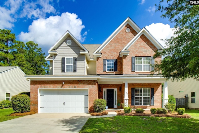 craftsman inspired home with driveway, a garage, a front lawn, a porch, and brick siding