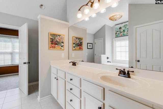 full bath with lofted ceiling, double vanity, a sink, and tile patterned floors