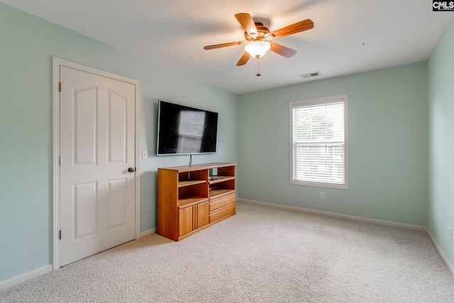 bedroom featuring baseboards, visible vents, and light colored carpet