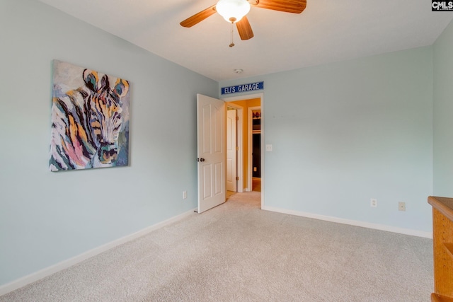 unfurnished room featuring baseboards, ceiling fan, and light colored carpet