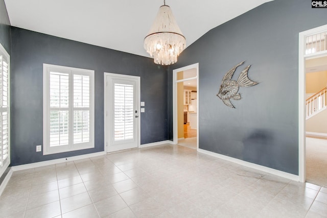 unfurnished room with baseboards, a notable chandelier, and light tile patterned flooring