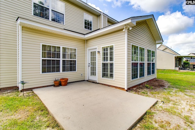 rear view of property with a patio area and a lawn