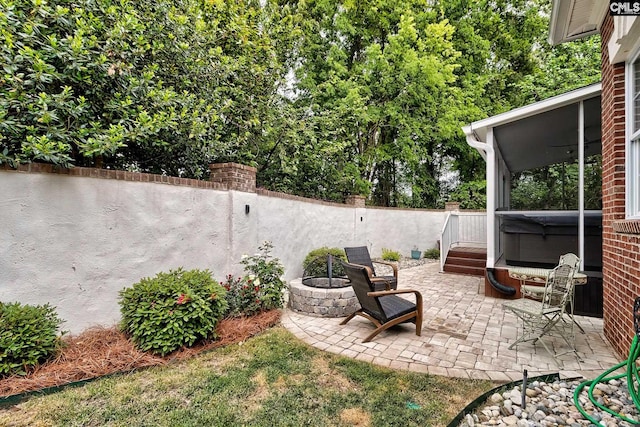 view of patio with a fire pit and a hot tub