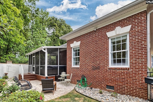 exterior space with ceiling fan, a patio area, and a sunroom