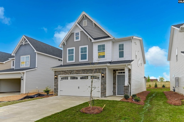 craftsman house featuring a garage and a front lawn