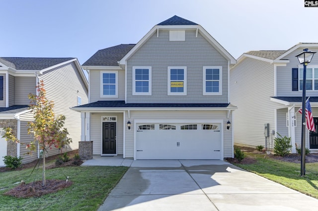 view of front of property featuring a garage and a front lawn