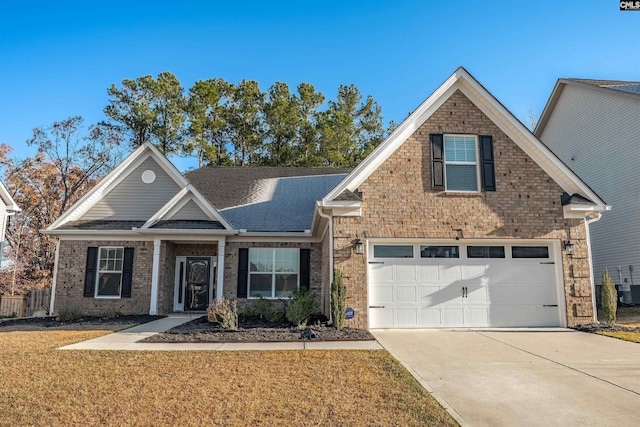 view of front of home featuring a front yard, a garage, and central air condition unit