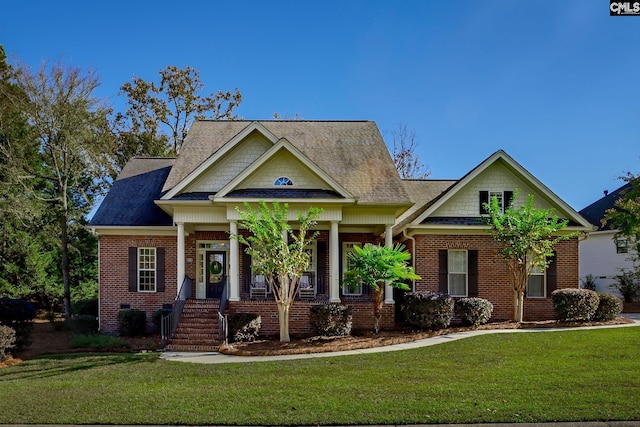 view of front of home with a porch and a front yard