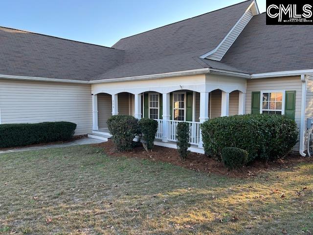 view of property exterior featuring a lawn and covered porch