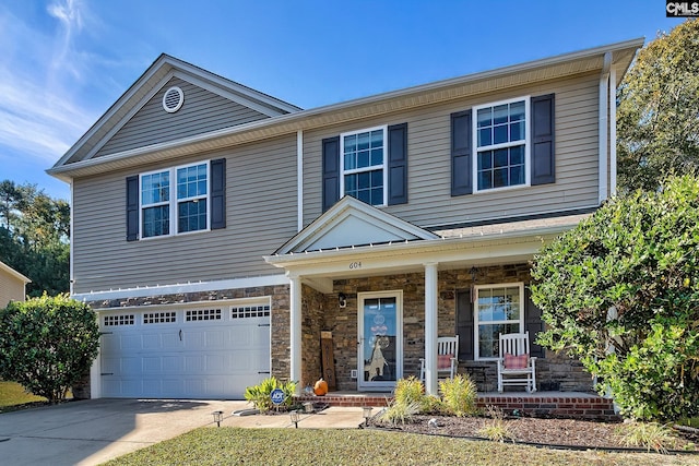 view of front of property with a porch and a garage