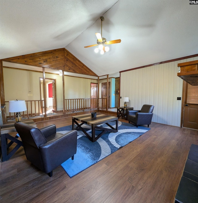 living room featuring a textured ceiling, ceiling fan, hardwood / wood-style flooring, lofted ceiling, and wood walls