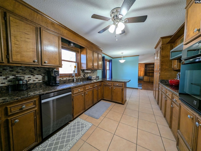 kitchen with dishwasher, oven, sink, hanging light fixtures, and tasteful backsplash