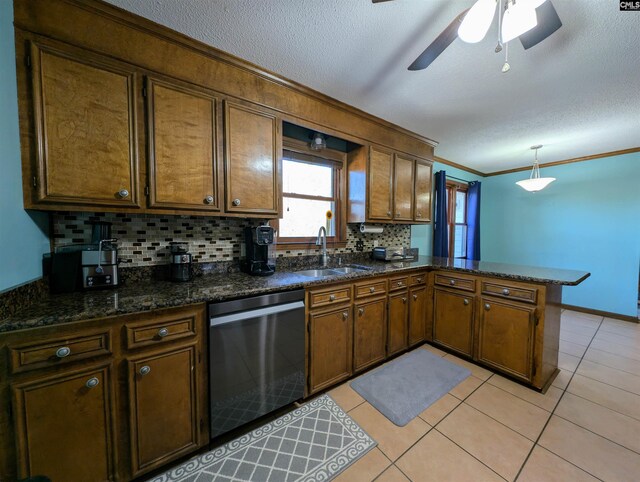 kitchen with sink, hanging light fixtures, stainless steel dishwasher, kitchen peninsula, and decorative backsplash