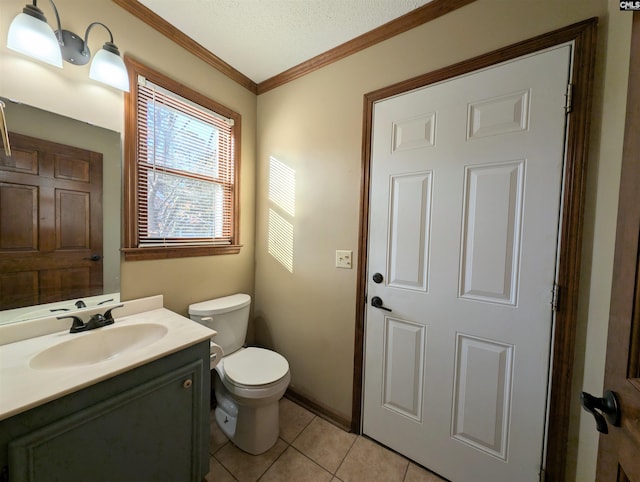 bathroom with tile patterned floors, vanity, a textured ceiling, crown molding, and toilet