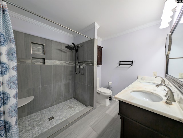 bathroom featuring a shower with shower curtain, vanity, and crown molding