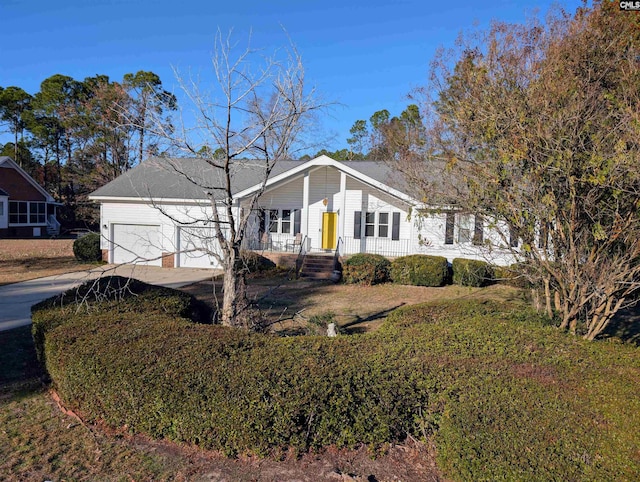 view of front of home featuring a porch and a garage