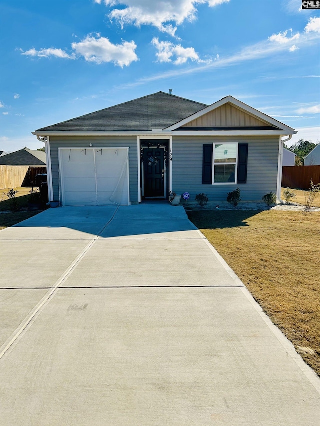 single story home featuring a garage and a front lawn