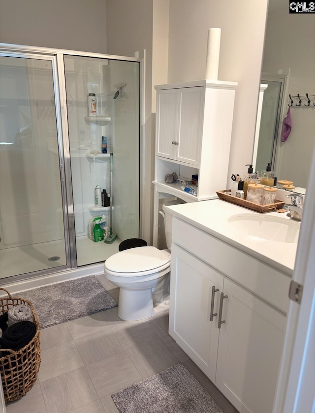 bathroom with vanity, an enclosed shower, and toilet