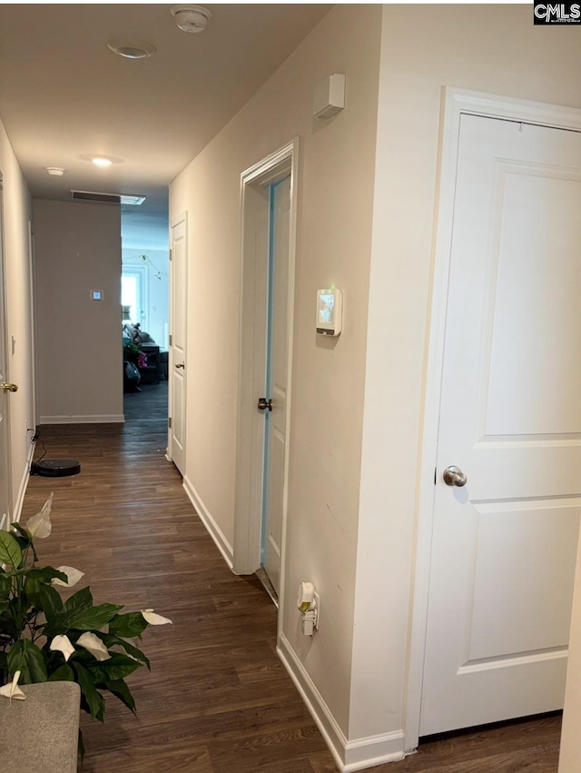 hall with dark hardwood / wood-style flooring