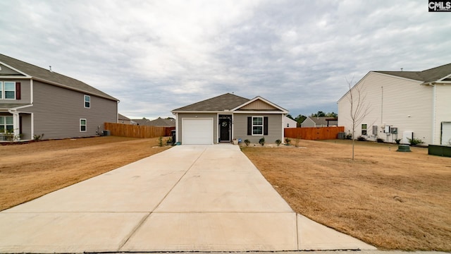 view of front of property featuring a garage and a front yard