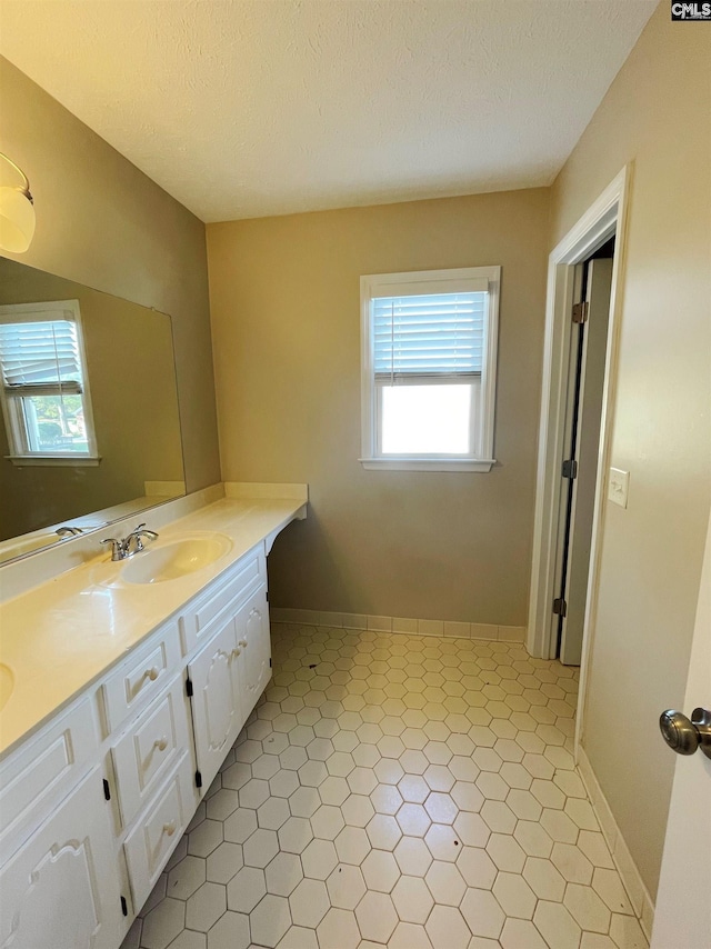 bathroom with vanity and a textured ceiling