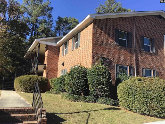 view of home's exterior with a yard