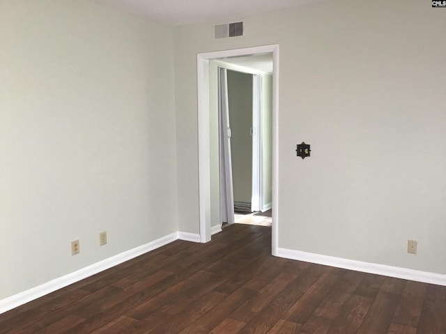 spare room with dark wood-type flooring