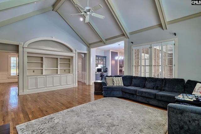 living room with a wealth of natural light, hardwood / wood-style floors, and high vaulted ceiling