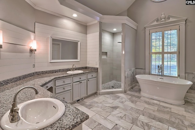 bathroom featuring vanity, ornamental molding, and independent shower and bath