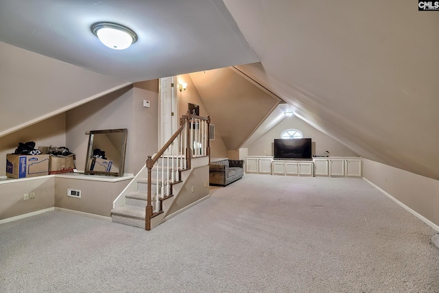 additional living space with carpet flooring and lofted ceiling