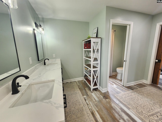 bathroom featuring hardwood / wood-style floors, vanity, and toilet