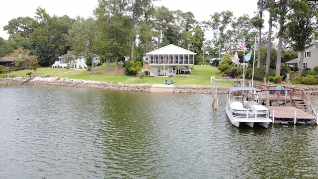 view of dock with a water view and a yard