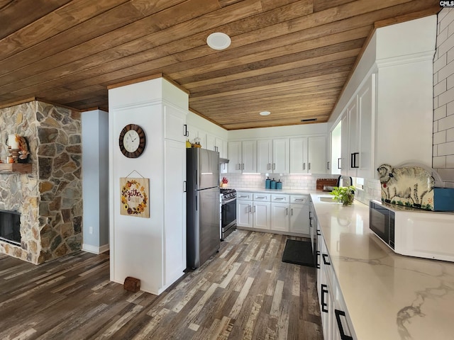 kitchen with white cabinets, backsplash, wooden ceiling, and stainless steel appliances