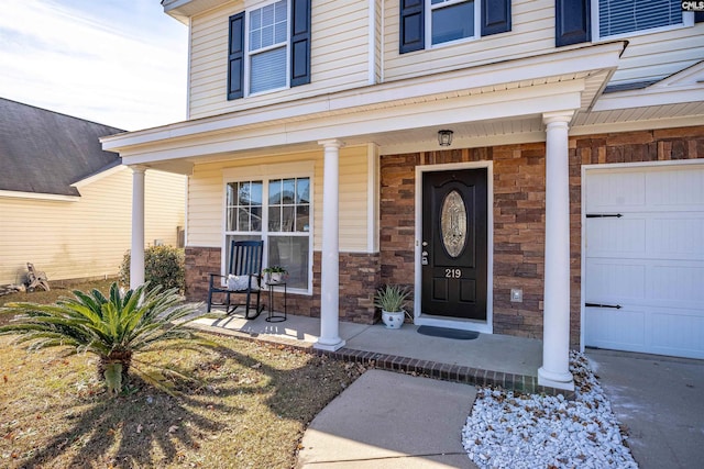 property entrance with a porch and a garage