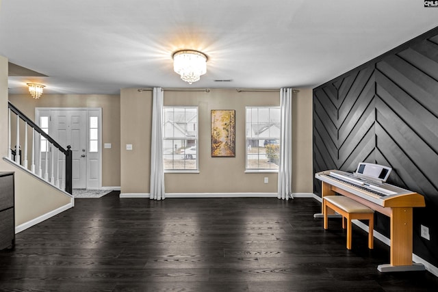 interior space featuring dark hardwood / wood-style flooring and a notable chandelier