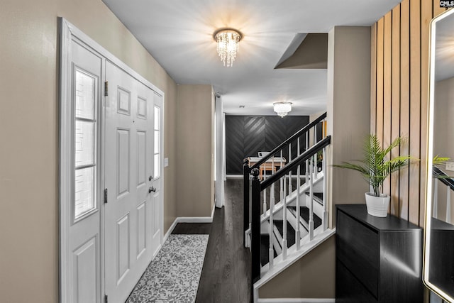 foyer featuring dark hardwood / wood-style flooring and an inviting chandelier