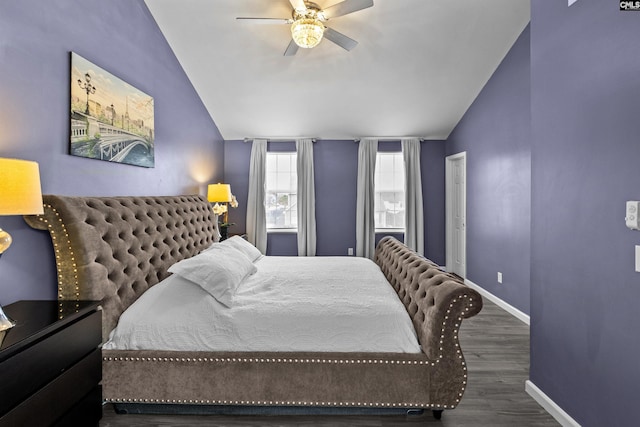 bedroom featuring dark hardwood / wood-style flooring, ceiling fan, and lofted ceiling