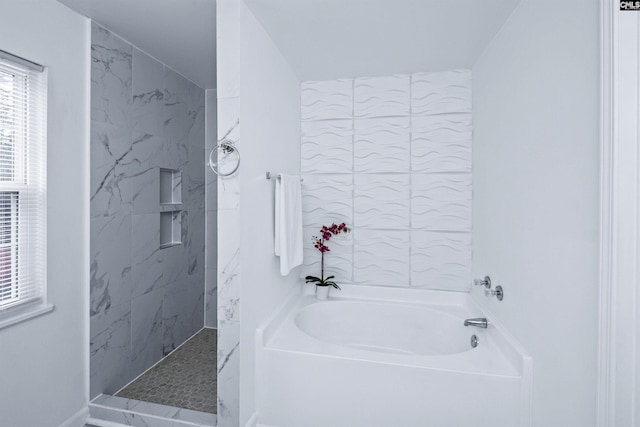 bathroom featuring shower with separate bathtub