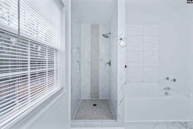 bathroom featuring shower with separate bathtub