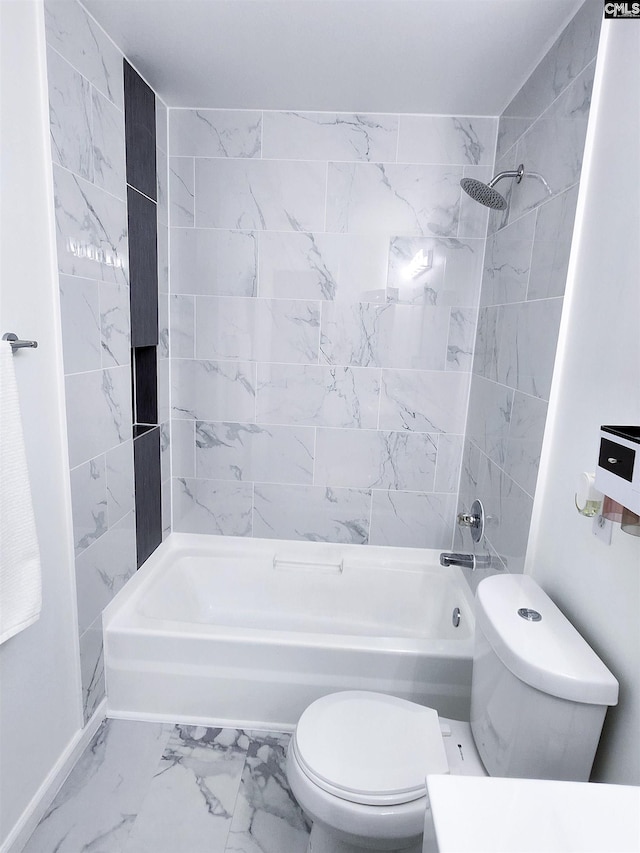 bathroom with tiled shower / bath combo and toilet