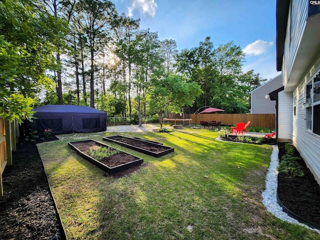 view of yard with a trampoline