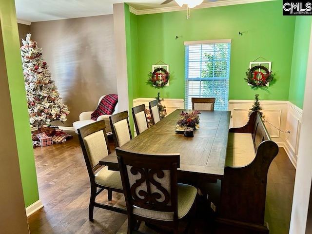 dining area with dark hardwood / wood-style flooring, ceiling fan, and ornamental molding