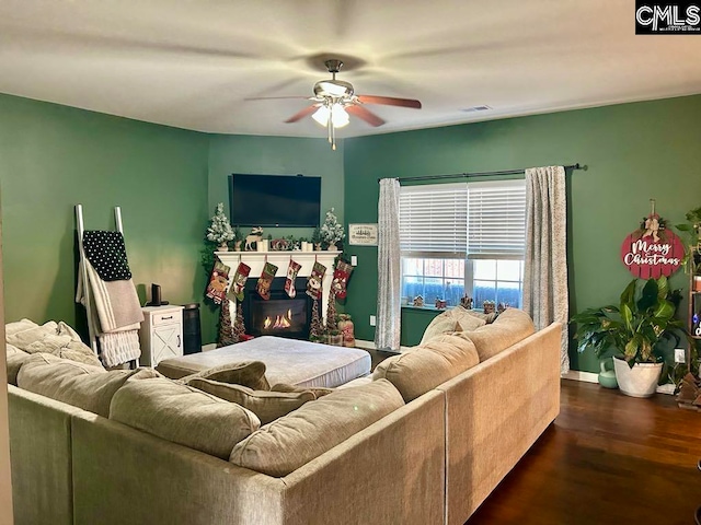 living room featuring dark hardwood / wood-style flooring and ceiling fan