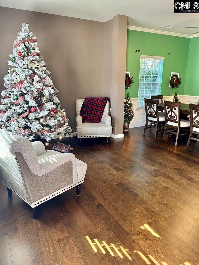 living room with hardwood / wood-style floors and ornamental molding